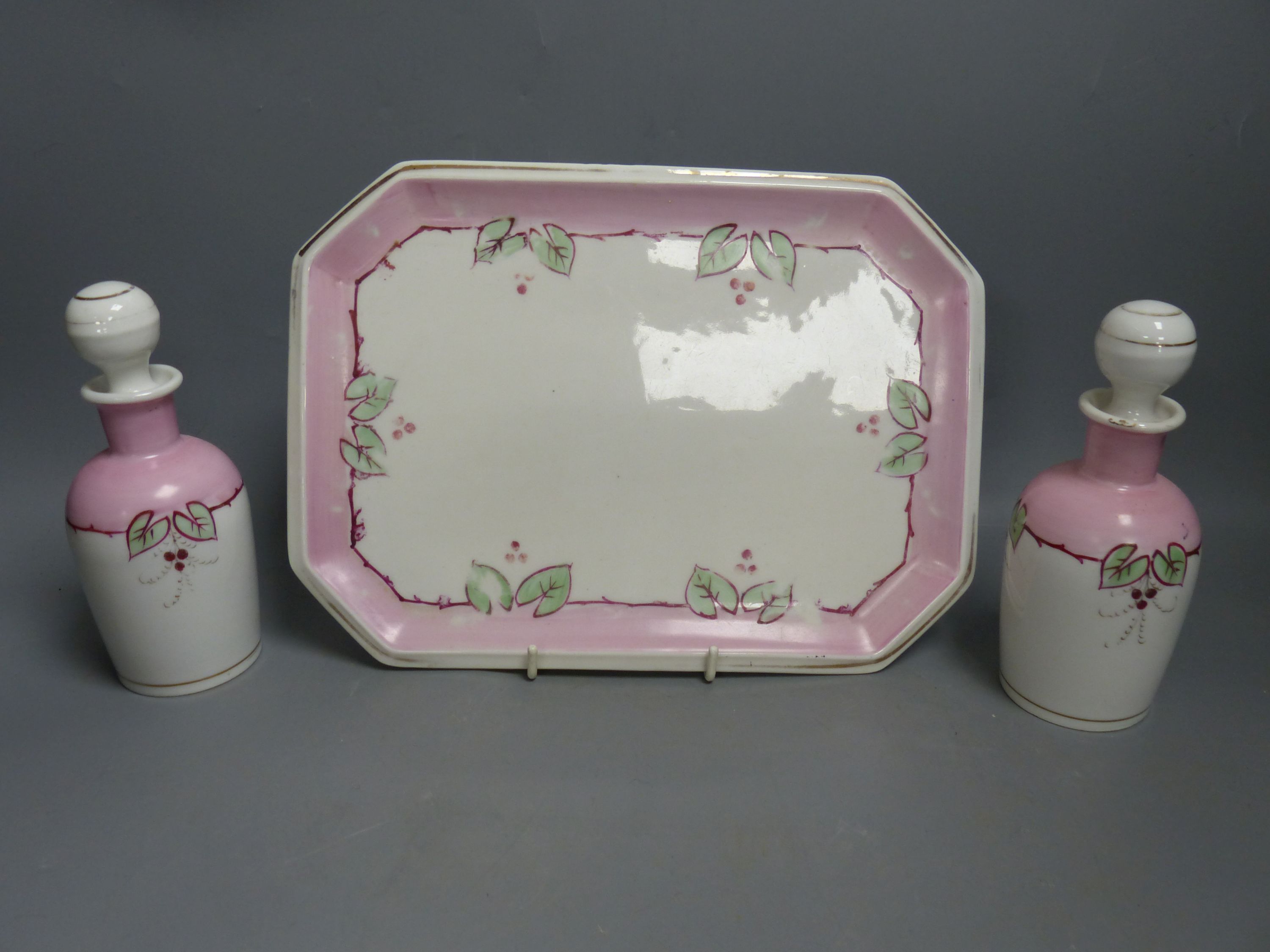 A Paris porcelain pink ground cache pot and a similar dressing table set, largest 27cm